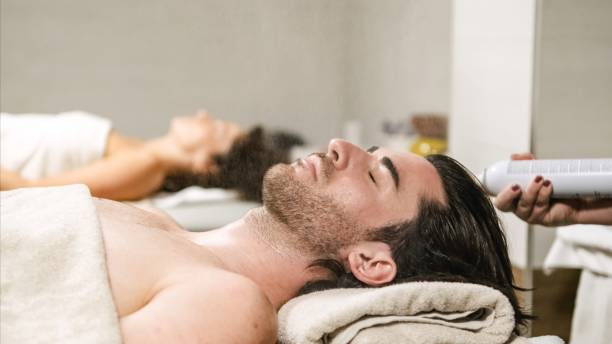 istock Beautician spraying water on man's face during spa treatment 2202899244
