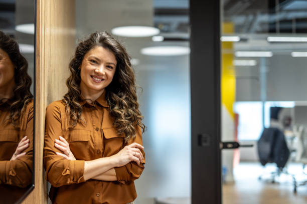istock Confident businesswoman smiling in modern office 2202900883