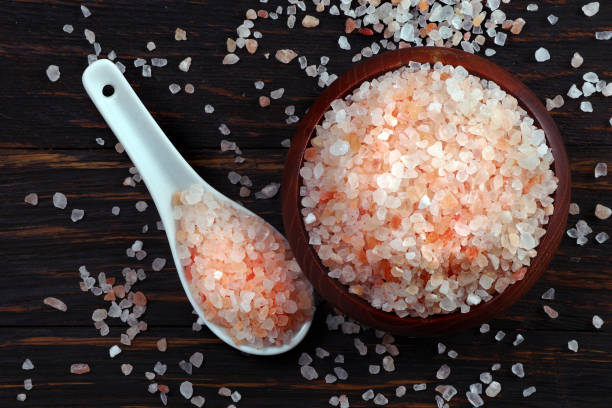istock pink himalayan salt in a spoon on the table. top view 2202902638
