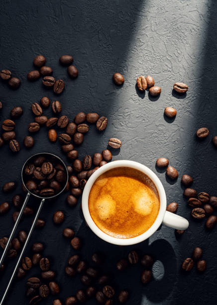 Top view of roasted coffee beans in coffee cup and spoon