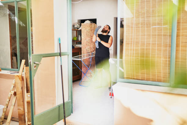 istock Man doing home chores and looking up while holding a sock 2202904888