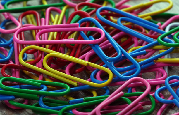 istock multicolored paper clip background. close up 2202906427