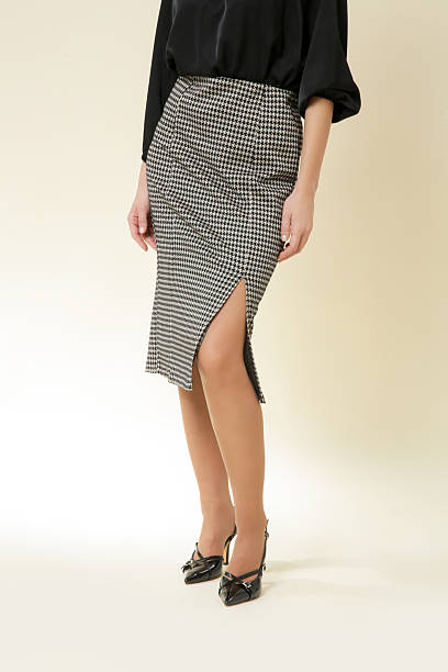 istock Female model wearing midi houndstooth i pencil skirt, studio shot 2202914532