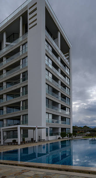 istock Modern architecture harmonizes with serene waters at a luxury resort amidst cloudy skies 2202915575