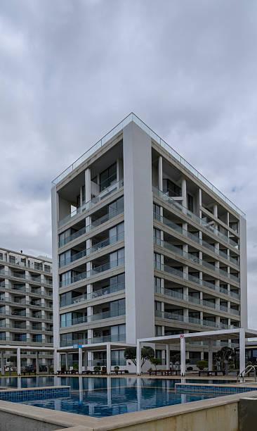 istock Modern architectural marvel with serene pool under cloudy skies in a contemporary urban setting 2202915584