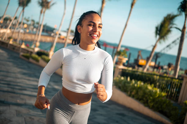 istock Active Hispanic Woman Jogging by the Sea 2202919982