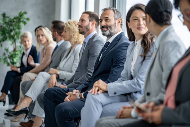 istock Group of Professionals Waiting for an Event to Begin 2202920521