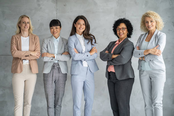 istock Professional Women Team Standing in a Bright Workspace 2202920541