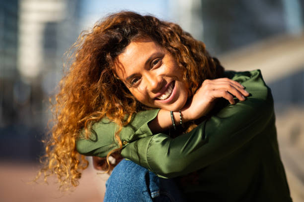 istock Beautiful hispanic woman sitting on steps outside 2202921592