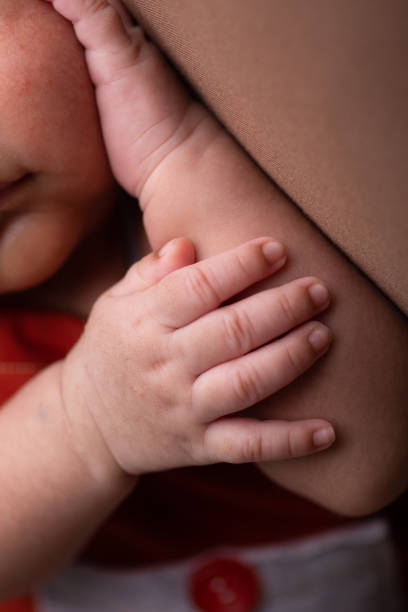 istock Little tiny delicate newborn human baby hands close up 2202923833
