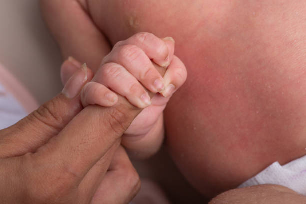 istock Little tiny delicate newborn human baby hands close up 2202925080