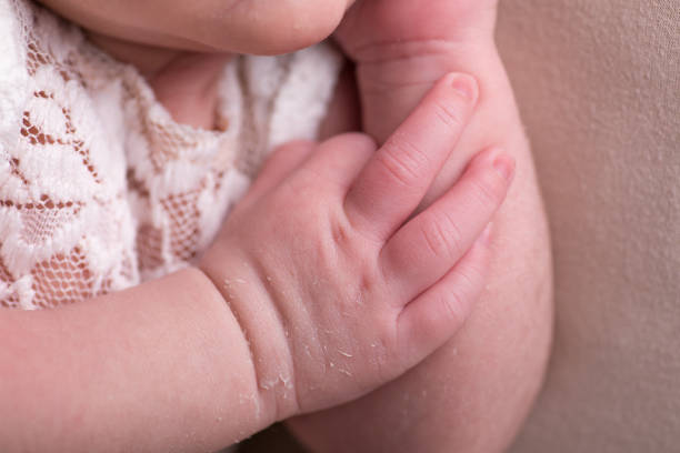 istock Little tiny delicate newborn human baby hands close up 2202926679
