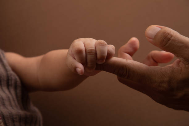 istock Little tiny delicate newborn human baby hands close up 2202926771