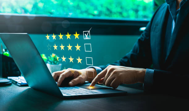 istock Businessman Using Laptop to Provide Five-Star Rating in Digital Customer Feedback Survey, Highlighting Quality Assurance, Customer Experience, and Online Review Management 2202933348