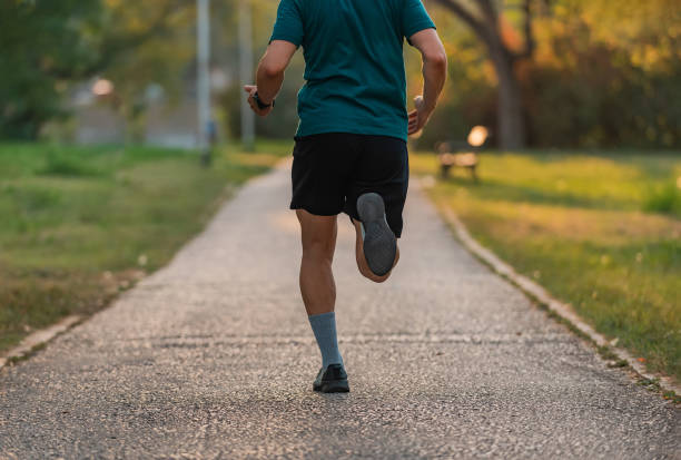 istock Runner man running or jogging at the park active healthy lifestyle. 2202933669