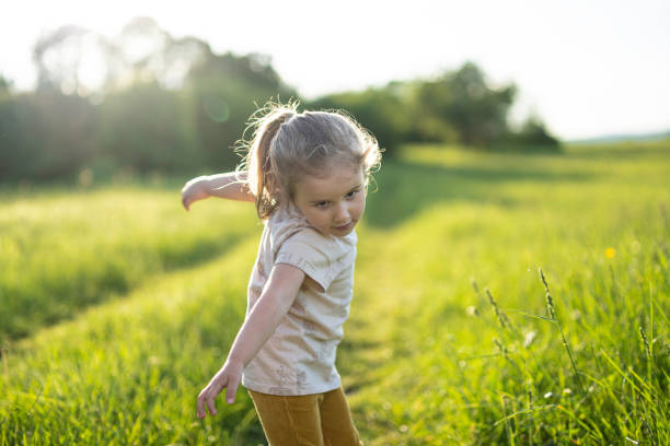 istock Girl Playing in Nature at Sunset, copy space. 2202936089