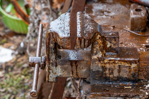 A rusty metal tool with a handle and a metal piece that looks like a screwdriver. The handle is rusted and the screwdriver is missing