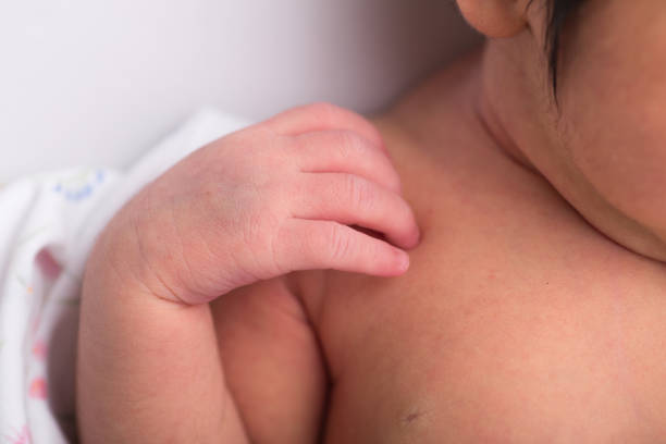 istock Little tiny delicate newborn human baby hands close up 2202940722