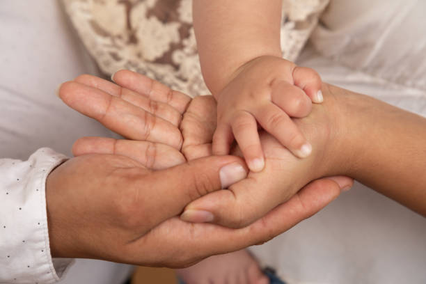 istock Little tiny delicate newborn human baby hands close up 2202940918
