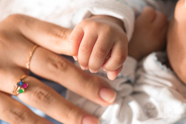 istock Little tiny delicate newborn human baby hands close up 2202940984