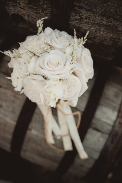 istock White rose wedding bouquet with ribbons and lace 2202943666