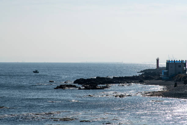istock sea horizon with rocky beach and beacon 2202948865