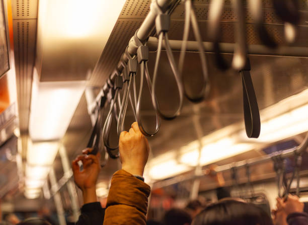 istock Woman’s hand holding on while traveling in the subway 2202952417