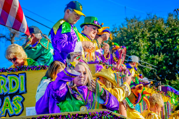 Mobile, Alabama, USA - Feb. 7, 2016: People throw beads from a Mardi Gras float during the Joe Cain Day Mardi Gras parade in Mobile, Alabama.