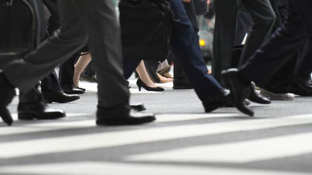 The feet of people walking at the intersection stock photo