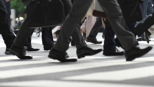 istock The feet of people walking at the intersection 2202959830