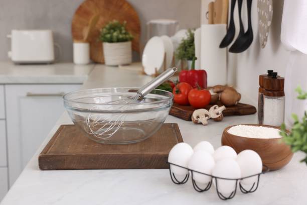 istock Metal whisk, bowl and different products on white table in kitchen 2202966566