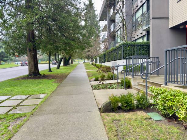 istock sidewalk and green plants next to a modern building 2202967679