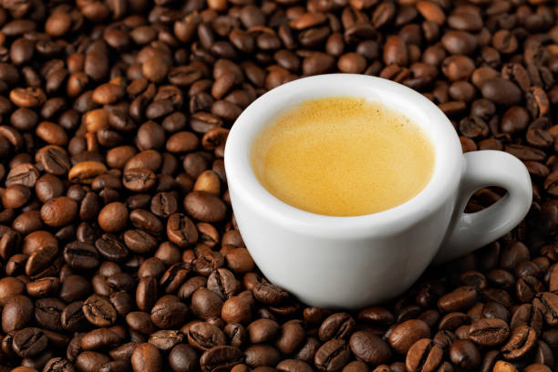 istock white espresso cup stands on roasted beans, highlighting rich crema and creating perfect background for coffee lovers 2202971155