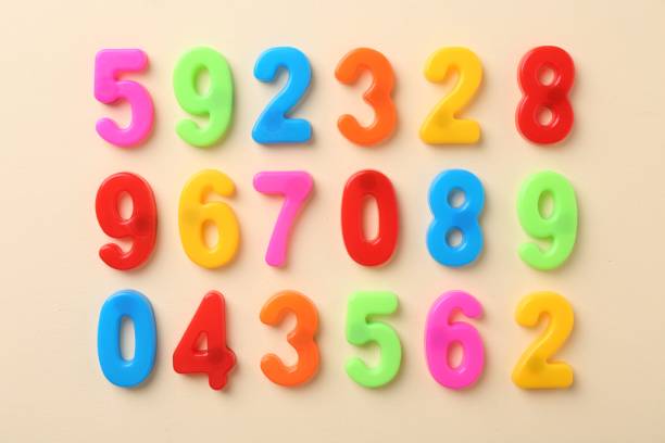 istock Colorful numbers on beige background, flat lay 2202972319