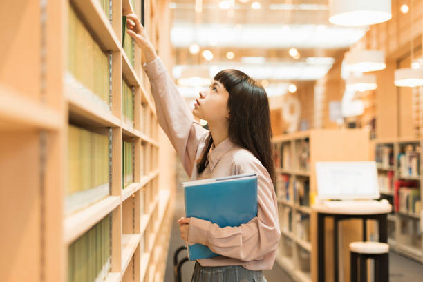 istock Female university student studying at the library 2202976562
