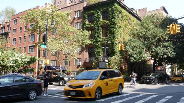 New York City Manhattan Irving street corner, Gramercy, USA. People, taxi cab. House wall, ivy plant New York City, United States, 6 Sept 2023: Manhattan Midtown Irving street corner, crossroad intersection, Gramercy, USA. People pedestrians. Yellow taxi. Red brick house wall covered ivy plant leaves grapevine texas city stock pictures, royalty-free photos & images
