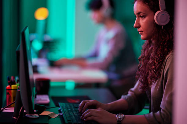 istock Focused female gamer playing a video game on PC. 2202981054
