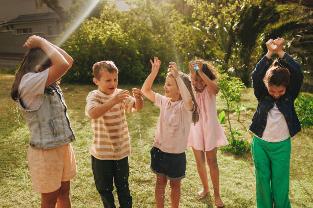istock Group of happy children having fun playing outdoors together 2202981963