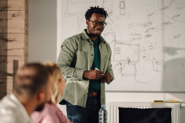 istock Confident male project manager leading presentation in modern office 2202982616