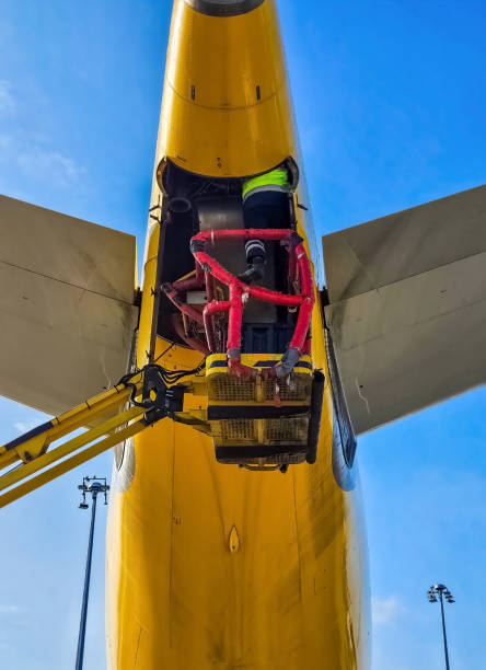 Aircraft maintenance work under the yellow fuselage with hydraulic lift. High quality photo