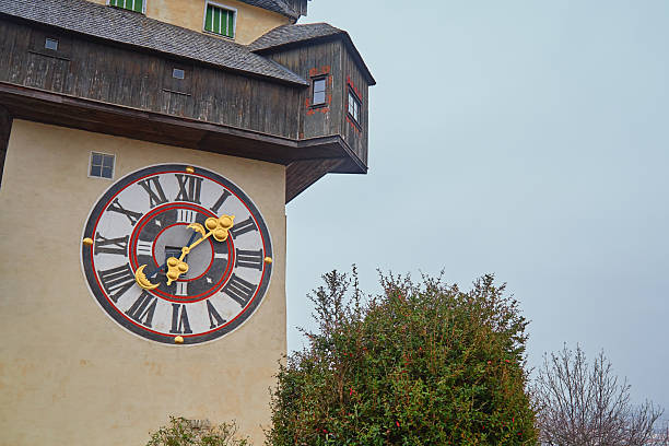 Famous Grazer Uhrturm clock tower with golden hands in Graz, Austria