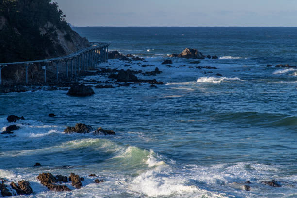 istock surf and wave on the rocky beach in winter 2202988543