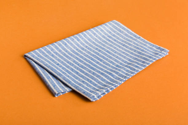 istock top view with blue kitchen napkin isolated on table background. Folded cloth for mockup with copy space, Flat lay. Minimal style 2202989598