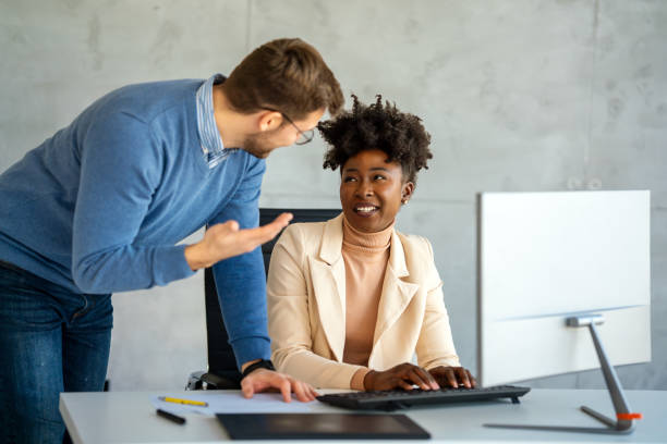 istock Group of young multi-ethnic startup business team collaborating on project in modern office 2202991644