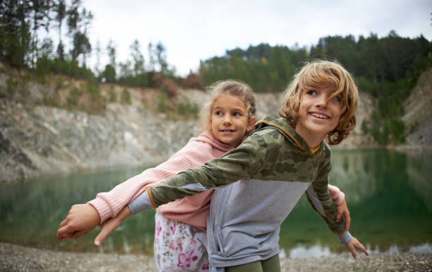 Beautiful children enjoying beautiful day on lake.