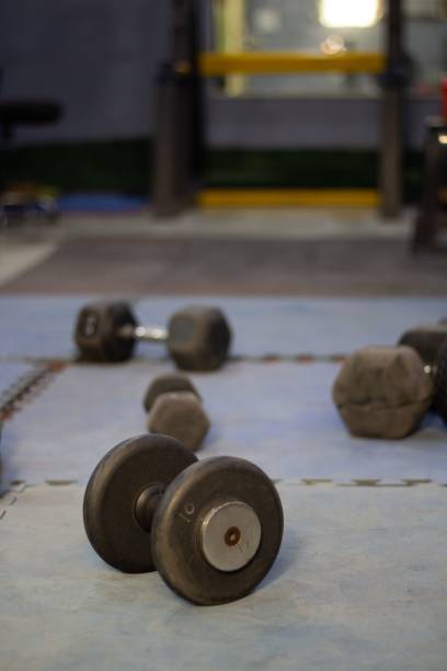 istock Dumbbells on gym floor 2202993844