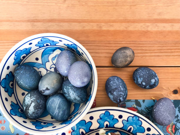 Cosmic Easter eggs dyed in hibiscus tea for Orthodox Easter. Deep blue, purple, and marbled textures create a galaxy effect with natural dye for holiday Easter tradition