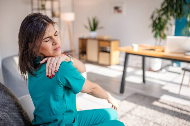 istock Female Nurse Feeling Pain at Home 2202994564