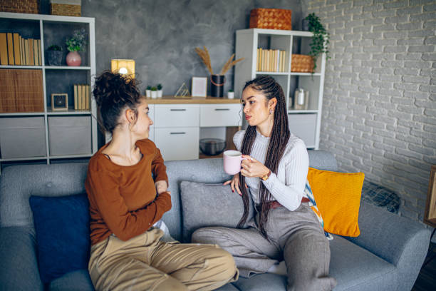 istock Two roommates are having a conversation in the living room 2202998043