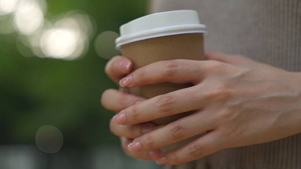 istock Woman holding a coffee cup 2202998047